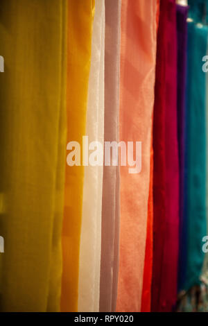 Coloured cloth hanging in shop Stock Photo