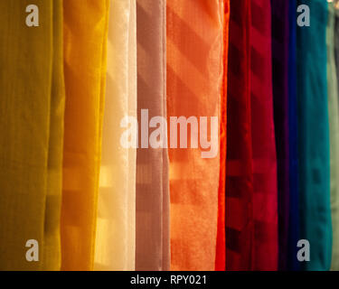 Coloured cloth hanging in shop Stock Photo