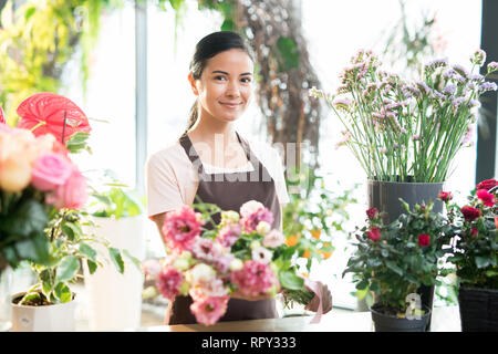 Girl working in florist shop Stock Photo