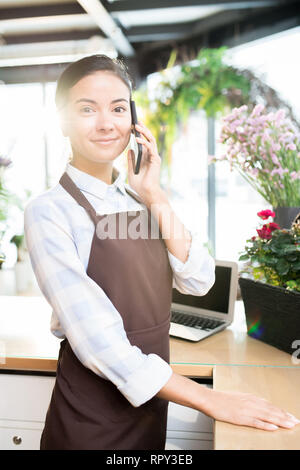 Florist with smartphone Stock Photo
