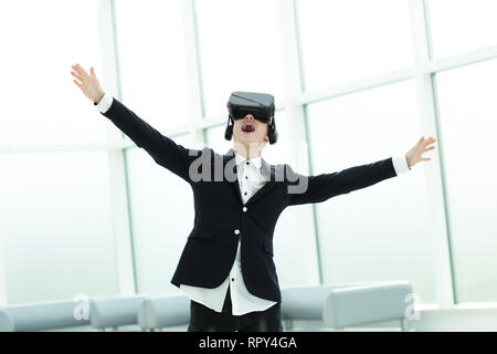 happy businessman in a helmet of a virtual reality standing in the office Stock Photo