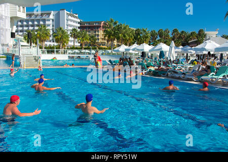 Alanya, Turkey - October 05, 2018. A group of people plays water polo in the blue clear water of the Kirman Sidera Luxury hotel pool. Fitness concept, Stock Photo