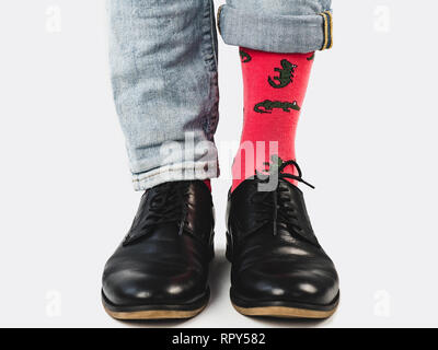 Businessman, trendy shoes, blue jeans and bright, colorful socks on a white, isolated background. Close-up. Style, fashion, beauty, elegance Stock Photo