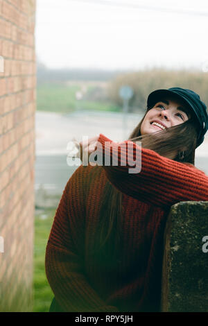 Attractive woman with hat laughing and smiling portrait in a rural scene Stock Photo