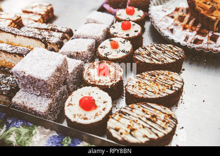 Different types of fresh handmade cakes for sale at sweet food market. Stock Photo