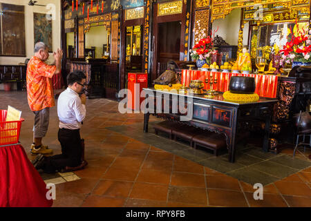 Worshipers Praying in Buddhist Taoist Cheng Hoon Teng Chinese Temple, Melaka, Malaysia. Stock Photo