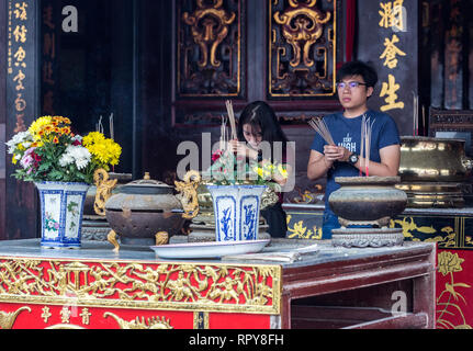 Young Worshipers with Incense Sticks in Buddhist Taoist Cheng Hoon Teng Chinese Temple, Melaka, Malaysia. Stock Photo