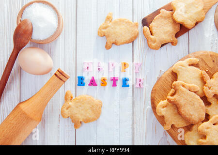 Happy Easter greeting. Baking Easter bunnies. Cookies with ingredients Stock Photo
