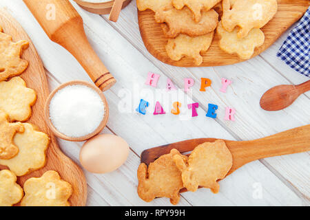 Happy Easter greeting. Baking Easter bunnies at home. Cookies with ingredients and bright title Stock Photo