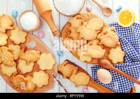 Happy Easter. Baking Easter bunnies. Ingredients with Easter decoration on wooden table Stock Photo