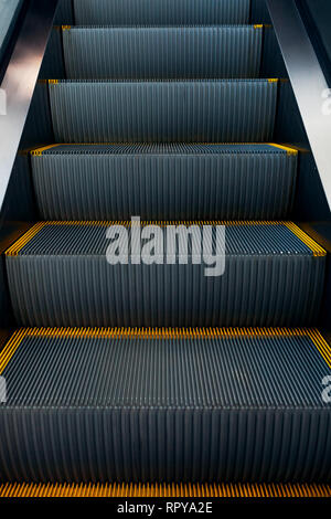 Modern escalator in shopping center. Electronic system moving. Empty escalator in business center. Stock Photo