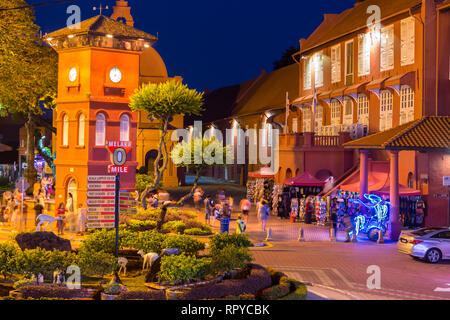 Stadthuys on right at night, Former Dutch Governor's Residence and Town Hall, Built 1650.  Illuminated Trishaw in lower right, waiting for tourists.   Stock Photo