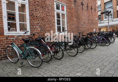 Large group of bicycles parked on cobblestones. Oldenburg. Lower Saxony. Germany. Stock Photo