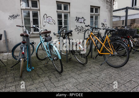 Large group of bicycles parked on cobblestones. Oldenburg. Lower Saxony. Germany. Stock Photo