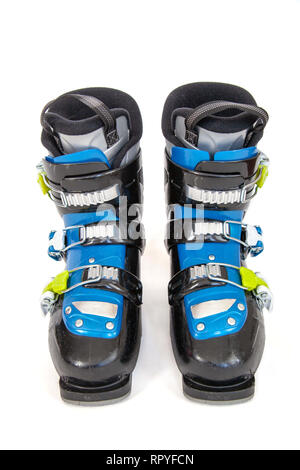 Pair of blue and black alpine ski boots with yellow buckles isolated on white background. Stock Photo