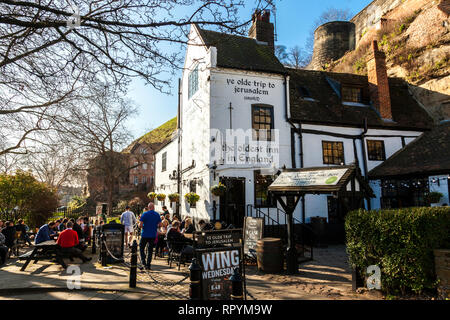 Nottingham, U.K. 23rd February 2019.  Lunchtime drinkers enjoying the warm sunshine outside Ye Olde Trip to Jerusalem in Nottingham, The inn is reputed to have been built in 1189 and is the oldest inn in England. According to legend the inn takes its name from the 12th Century Crusades to the Holy Land with Crusaders stopping for a drink on their way to Jerusalem. Credit: Mark Richardson/Alamy Live News Stock Photo
