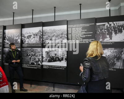 POLAND  -  Auschwitz museum  Tourist sites in the former concentration camp.Tour guide explaining exhibit. Stock Photo