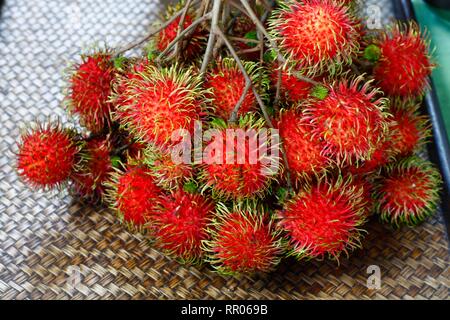 bunch of fresh Rambutan, red and hairly tropical fruits Stock Photo