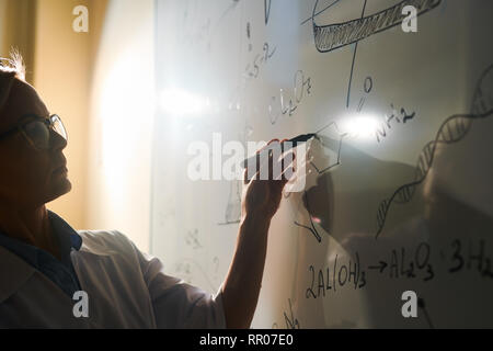 Teacher by blackboard Stock Photo