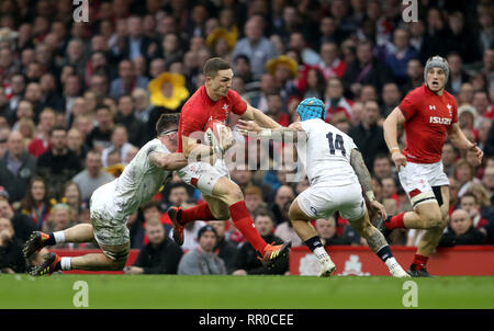 Wales' George North (centre) is tackled by England's Tom Curry (left) and Jack Nowell during the Guinness Six Nations match at the Principality Stadium, Cardiff. Stock Photo