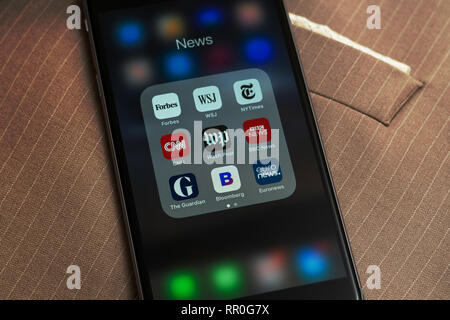 Black Apple iPhone with icons of News media: Forbes, WSJ, NY Times, CNN, WP, BBC News, Guardian, Bloomberg and Euronews applications on screen. Stock Photo
