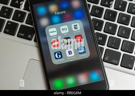 Black Apple iPhone with icons of News media: Forbes, WSJ, NY Times, CNN, WP, BBC News, Guardian, Bloomberg and Euronews applications on screen. Stock Photo