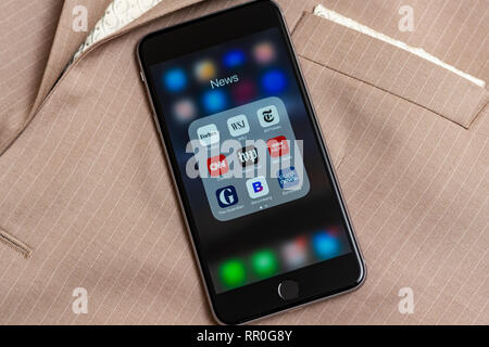 Black Apple iPhone with icons of News media: Forbes, WSJ, NY Times, CNN, WP, BBC News, Guardian, Bloomberg and Euronews applications on screen. Stock Photo