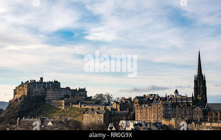 View over rooftops and chimneys, Old Town, Edinburgh Castle rock and The Hub church spire on the Royal Mile, Scotland, UK Stock Photo