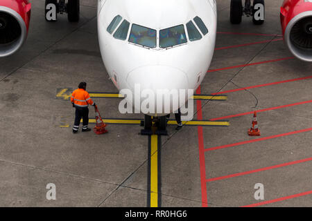 View of a plane on a runway at an international airport during the preparation for takeoff Stock Photo