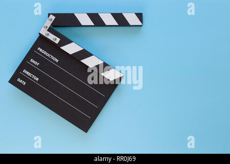 black clapperboard isolated on color background, flat lay Stock Photo