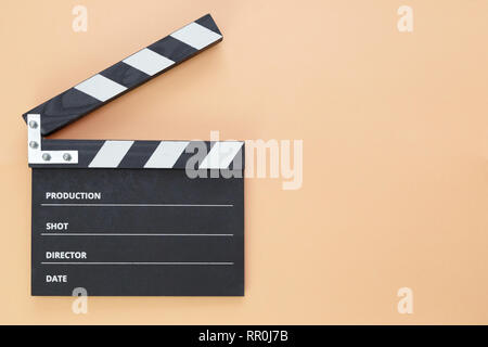 black clapperboard isolated on color background, flat lay Stock Photo