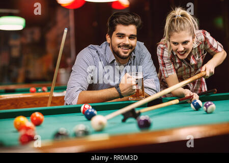 billiard game- smiling couples playing pool game Stock Photo