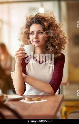 Curly girl have breakfast in restaurant Stock Photo