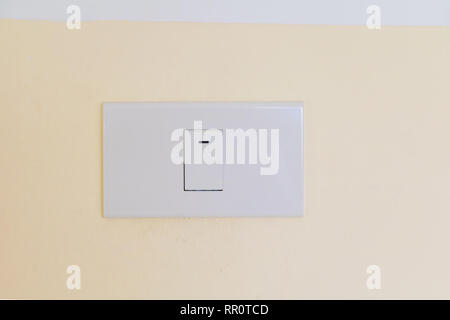 electricity switch white on wall yellow Stock Photo