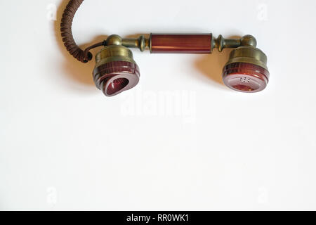 Phone call concept: a phone receiver dangling with copy space Stock Photo