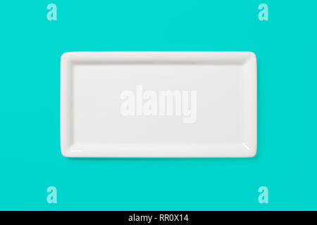 Empty white angular plate on pastel colored green background, view directly from above, clipping path included Stock Photo