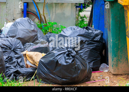 Pile black garbage roadside and Rain drops on the bag  in the city with copy space add text Stock Photo