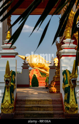 Stunning view of the reclining buddha statue in Pha That Luang complex. Pha That Luang is a Buddhist Temples complex in Vientiane, Laos Stock Photo