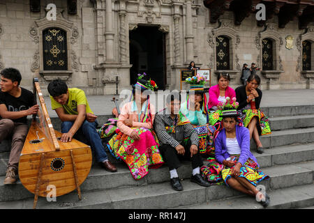 LIMA, PERU - NOVEMBER 04, 2015: Peruvians in national costumes on the steps the Basilica Cathedral of Lima located in the Plaza Mayor in Lima, Peru Stock Photo