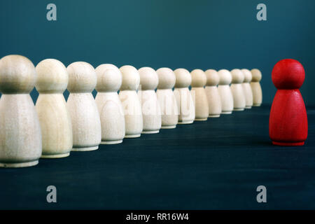 Wooden figurines as symbol of Team leader and staff. Management and leadership. Stock Photo