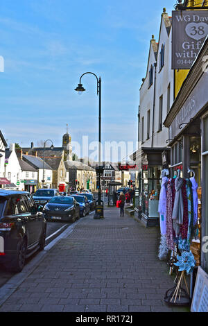A street view of the High Street in Cowbridge with it's mix of famous brands and small local specialist shops.The old Town Hall is in the background. Stock Photo