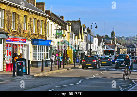 A general street view of the High Street in Cowbridge with it's eclectic mix of famous brands and small local specialist shops. Cyclist cars & buses. Stock Photo