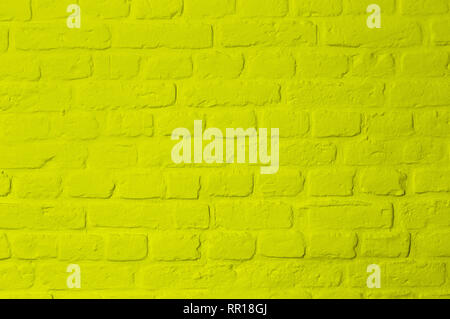Pastel bright lemon yellow colored brick stone wall, full frame, image background Stock Photo