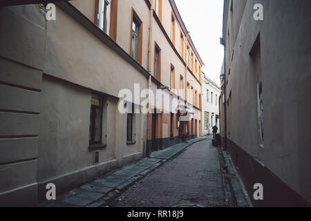 Ancient narrow Vilnius street with old architecture and winter background Stock Photo