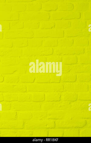 Pastel bright lemon yellow colored brickstone wall, full frame, image background Stock Photo