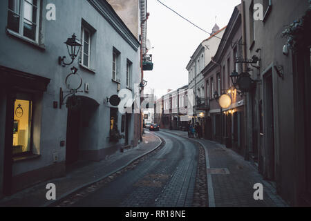 Ancient narrow Vilnius street with old architecture and winter background Stock Photo