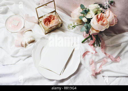 Vintage bedroom still life scene. Wedding, birthday bouquet of pink English roses, Ranunculus flowers and eucalyptus. Greeting card mockup on plate Stock Photo