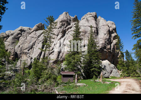 The road leading to the trailhead for Little Devils Tower rock feature in Custer State Park in the Black Hills area of South Dakota. Stock Photo