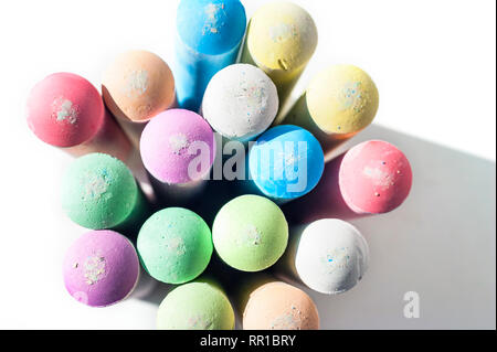 Pack of Jumbo Sidewalk Chalk, Assorted Colors, Bold Tips Casting Shadow on White Background. Top View. Stock Photo