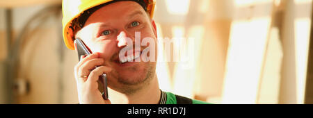 Carpenter talking on phone in hardware store Stock Photo
